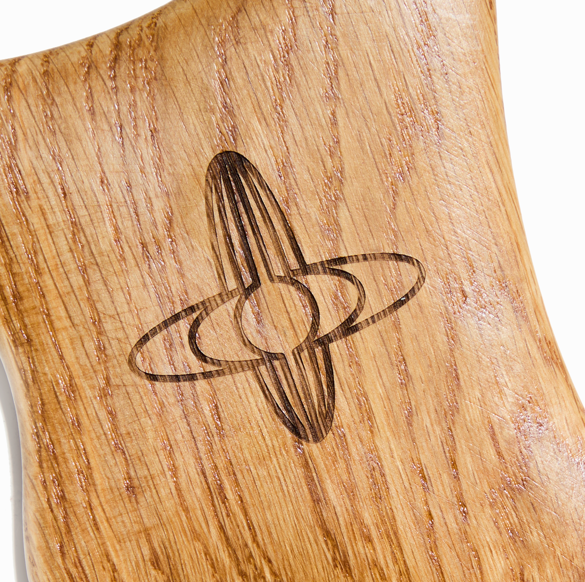 Close-up of wooden gua sha tool showing smooth texture and ergonomic shape for full-body massage and lymphatic drainage.