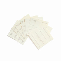 Flat lay of affirmation-inscribed incense papers with visible text and natural paper texture.