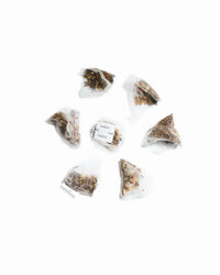 Close-up of Smooth Sailing Herbal Tea bag showing rooibos, cinnamon, and tulsi herbs for grounding and relaxation.