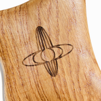 Close-up of wooden gua sha tool showing smooth texture and ergonomic shape for full-body massage and lymphatic drainage.
